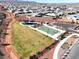 Aerial view featuring a community park with basketball court, playground, and desert landscape at 10239 Meandering Dell Ave, Las Vegas, NV 89166