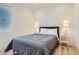 Bright bedroom features a queen bed with a grey comforter, two white nightstands, and a large window at 10239 Meandering Dell Ave, Las Vegas, NV 89166