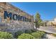 Stone wall entrance to Montrose community with manicured landscaping and clear blue sky at 10239 Meandering Dell Ave, Las Vegas, NV 89166