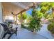 Inviting backyard with covered patio, ceiling fan, lush greenery, and climbing flowering vines at 10413 Rising Harbor Ave, Las Vegas, NV 89129