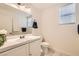 Bright bathroom featuring a single sink vanity, white tile countertop, and window with horizontal blinds at 10413 Rising Harbor Ave, Las Vegas, NV 89129
