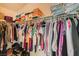 Walk-in closet well-organized with clothing racks, shoe storage, and shelves for a tidy and functional space at 10413 Rising Harbor Ave, Las Vegas, NV 89129