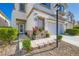 Charming two-story home with well-manicured landscaping, a two-car garage, and a covered porch at 10413 Rising Harbor Ave, Las Vegas, NV 89129