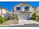 Charming two-story home with a well-manicured front yard, attached garage and desert landscaping at 10413 Rising Harbor Ave, Las Vegas, NV 89129