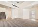 Bright living room with neutral tones, high ceilings, staircase, and large window door for a spacious feel at 10413 Rising Harbor Ave, Las Vegas, NV 89129