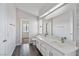 Bathroom with dual sinks, a large mirror, and a separate area for the toilet and shower/tub combo at 120 Wynntry Dr, Henderson, NV 89074
