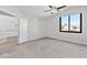 Bedroom with neutral carpet, a window with a view, and an entry to the hallway to the left at 120 Wynntry Dr, Henderson, NV 89074