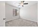 A light-filled bedroom with carpet flooring, neutral walls, and a ceiling fan at 120 Wynntry Dr, Henderson, NV 89074