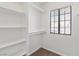 Walk-in closet with built-in shelves and a small window, offering ample storage and natural light at 120 Wynntry Dr, Henderson, NV 89074