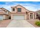 Charming home featuring a two-car garage, desert landscaping, and a red tile roof at 120 Wynntry Dr, Henderson, NV 89074