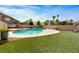 Backyard oasis features an in-ground pool, lush grass, and beautiful landscaping at 120 Wynntry Dr, Henderson, NV 89074