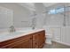 Bright bathroom with double vanity, tile flooring, and a walk-in tub with shower at 121 Staplehurst Ave, Henderson, NV 89002