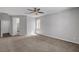 Large bedroom with neutral carpet, ceiling fan, and bright natural light at 121 Staplehurst Ave, Henderson, NV 89002