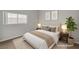 A light and airy staged bedroom with a queen-sized bed and coordinating neutral decor at 121 Staplehurst Ave, Henderson, NV 89002