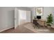 Home office area featuring a desk, comfortable chair, and view of a bedroom at 121 Staplehurst Ave, Henderson, NV 89002