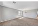 Spacious living room with carpet flooring, large windows, and chandelier lighting at 121 Staplehurst Ave, Henderson, NV 89002
