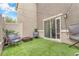 Charming backyard with artificial grass, modern seating and string lights, perfect for outdoor relaxation at 12280 Golden Wreath Rd # 3, Las Vegas, NV 89183