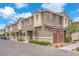 Attractive townhome exterior with desert landscaping, visible street, and partial blue sky at 12280 Golden Wreath Rd # 3, Las Vegas, NV 89183