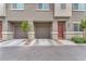 Two-car garage and front door with neutral exterior paint scheme and well-maintained landscaping at 12280 Golden Wreath Rd # 3, Las Vegas, NV 89183