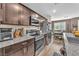 Modern kitchen with stainless steel appliances, granite countertops and seamless flow to dining area at 12280 Golden Wreath Rd # 3, Las Vegas, NV 89183