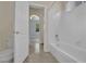 En-suite bathroom featuring a bathtub with white tile surround, a white toilet, and access to the bedroom at 1324 European Dr, Henderson, NV 89052