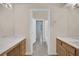 En-suite bathroom featuring dual vanities, tile flooring, and a separate water closet and bathtub/shower at 1324 European Dr, Henderson, NV 89052