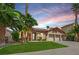 Charming home with a well-manicured lawn, mature palm trees, and a two-car garage at 1324 European Dr, Henderson, NV 89052