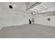 Bright and spacious garage with white walls and overhead storage shelves at 1324 European Dr, Henderson, NV 89052