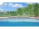 Sparkling swimming pool with tile accents and a calming water feature in a serene setting at 1324 European Dr, Henderson, NV 89052