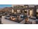 Beautiful outdoor living space with pools, lounging areas, and outdoor cooking with scenic views at 1491 Reims Dr, Henderson, NV 89012