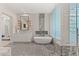 Elegant bathroom with marble accents, a luxurious standalone tub, glass enclosed shower and large windows at 1491 Reims Dr, Henderson, NV 89012