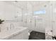 Sleek bathroom featuring white tile, glass shower and marble vanity at 1491 Reims Dr, Henderson, NV 89012
