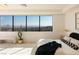 Bright and airy bedroom with a large window offering scenic views, modern furnishings, and stylish decor at 1491 Reims Dr, Henderson, NV 89012