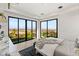 A bright bedroom with floor to ceiling glass doors offer a view of the city at 1491 Reims Dr, Henderson, NV 89012