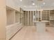 Spacious closet with ample storage, custom shelving and a central marble island at 1491 Reims Dr, Henderson, NV 89012