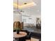 Bright dining area featuring modern lighting, an open floor plan and sleek white and black color palette at 1491 Reims Dr, Henderson, NV 89012