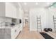 Bright exercise room with marble counters, a sink, wooden floors, mirrors and exercise equipment at 1491 Reims Dr, Henderson, NV 89012