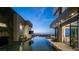 Stunning infinity pool overlooking the city lights, with outdoor seating and a fire pit at 1491 Reims Dr, Henderson, NV 89012