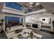 Open-concept living space with a modern fireplace, luxurious seating, and large windows offering panoramic views at 1491 Reims Dr, Henderson, NV 89012