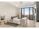 Elegant main bedroom features a fireplace, floor-to-ceiling windows with city views, and minimalist decor at 1491 Reims Dr, Henderson, NV 89012