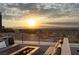 Outdoor patio featuring fire pit and scenic city views at sunset at 1491 Reims Dr, Henderson, NV 89012