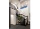 Elegant staircase with modern railings, a decorative chandelier and well-placed greenery at 1491 Reims Dr, Henderson, NV 89012