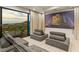 Home theater featuring a large screen, comfortable seating, and scenic views at 1491 Reims Dr, Henderson, NV 89012