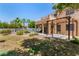 The home's large backyard features mature landscaping, a pool, and a covered patio area at 1798 Lakewood Dr, Henderson, NV 89012