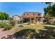 The home's backyard features solar panels and a covered patio along with mature landscaping and trees at 1798 Lakewood Dr, Henderson, NV 89012