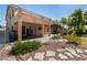 The home's backyard features a covered patio, rock garden, and access to the second story balcony at 1798 Lakewood Dr, Henderson, NV 89012