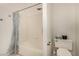 A full bathtub with tiled walls and a shower curtain, alongside a toilet at 1798 Lakewood Dr, Henderson, NV 89012