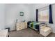 Bright bedroom with large window, bed, and storage; carpeted floors and blue accents at 1798 Lakewood Dr, Henderson, NV 89012