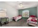 Cozy bedroom with twin beds, a desk, and plenty of natural light at 1798 Lakewood Dr, Henderson, NV 89012