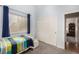 This cozy bedroom features carpeted floors, a bright window, and closet with sliding doors at 1798 Lakewood Dr, Henderson, NV 89012